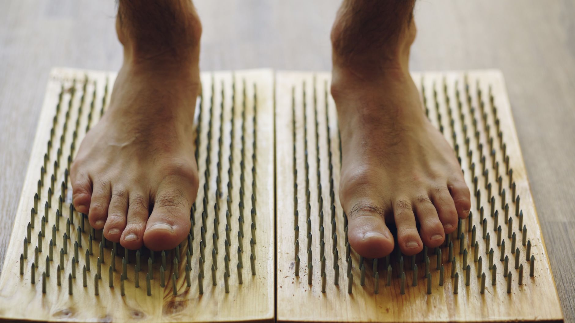 Pieds nus sur planche de massage pour soulager les tensions