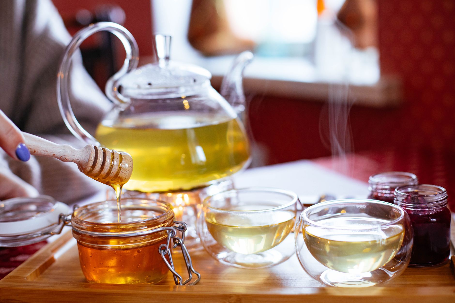 Tisane chaude servie avec du miel dans des tasses en verre